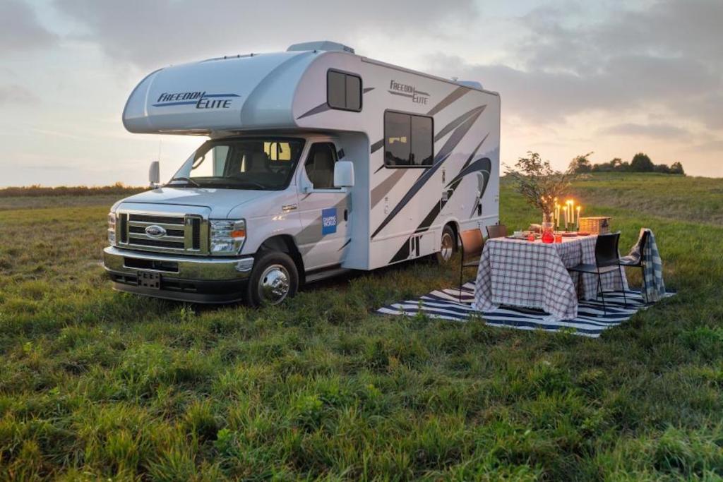 2021 Freedom Elite 22HEF motorhome parked in the grass with picnic