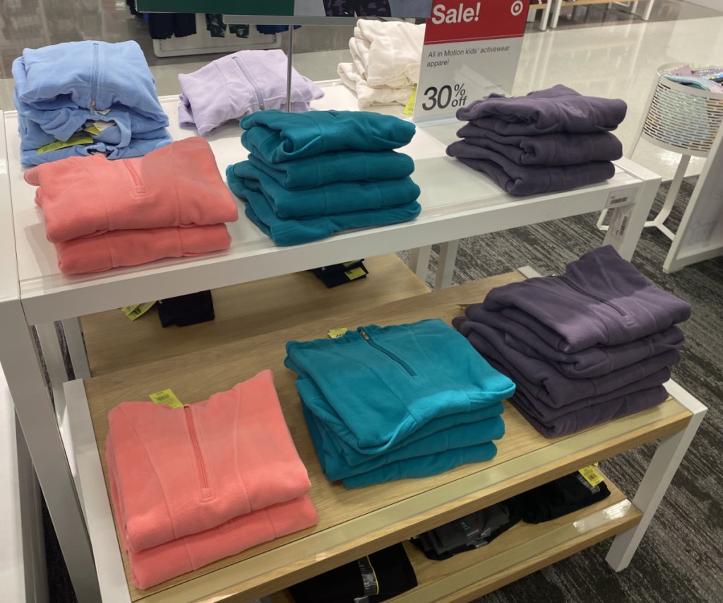 kids fleece sweatshirts folded on display table in store