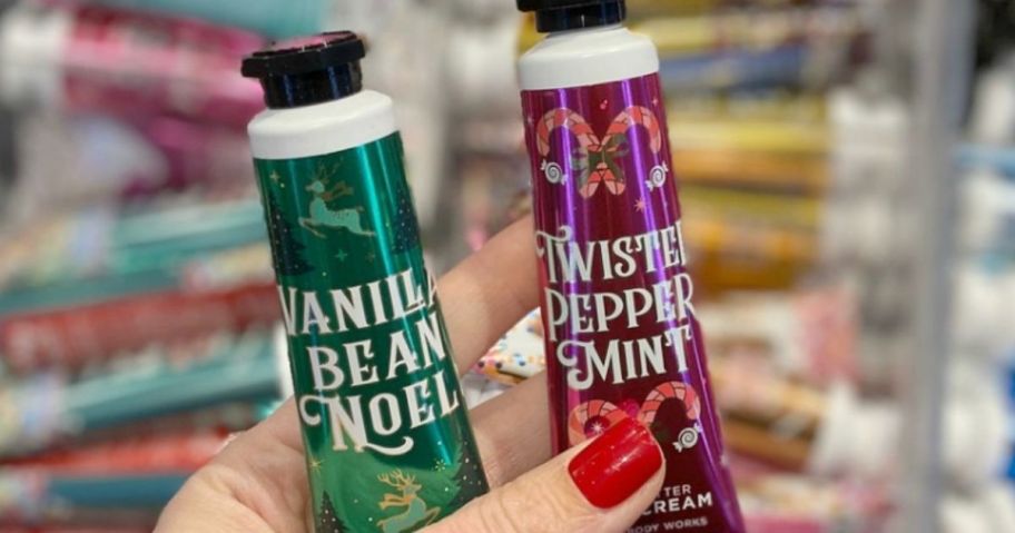 hand holding two Bath & Body Works hand creams