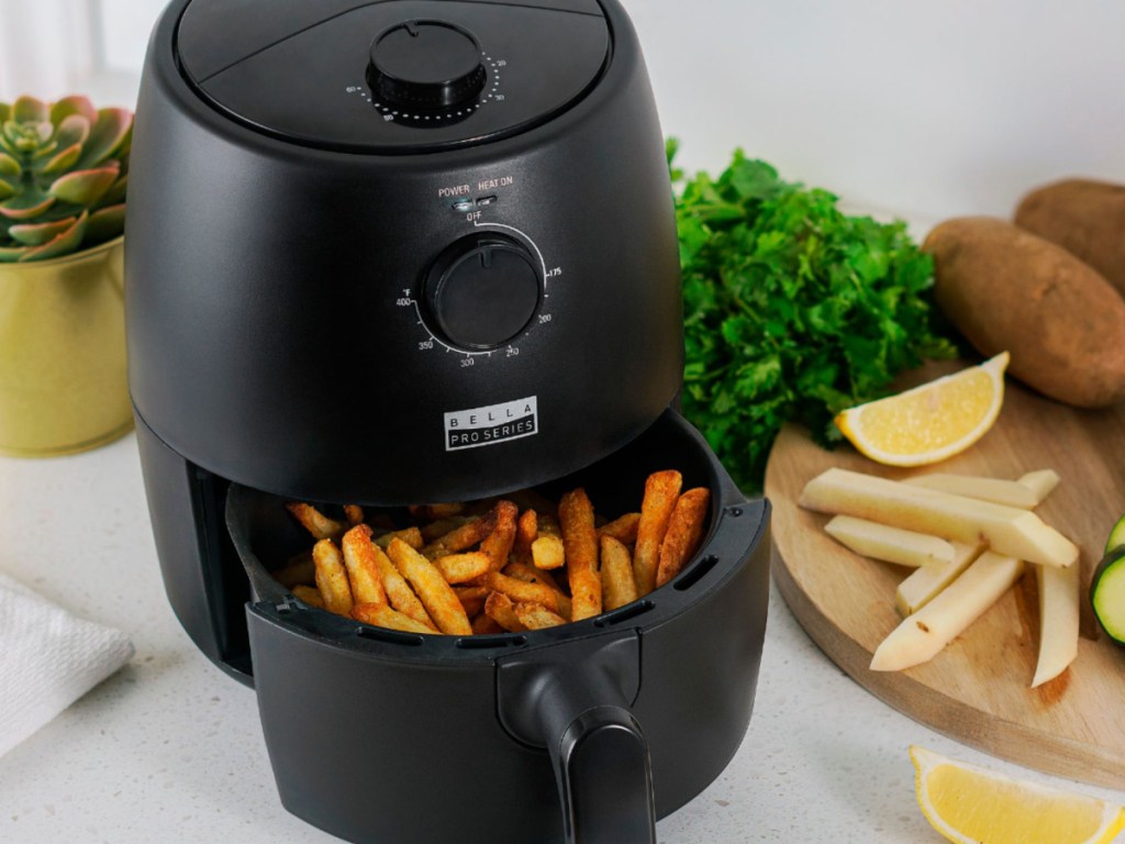 bella pro air fryer eith french fries in the basket on a kitchen counter