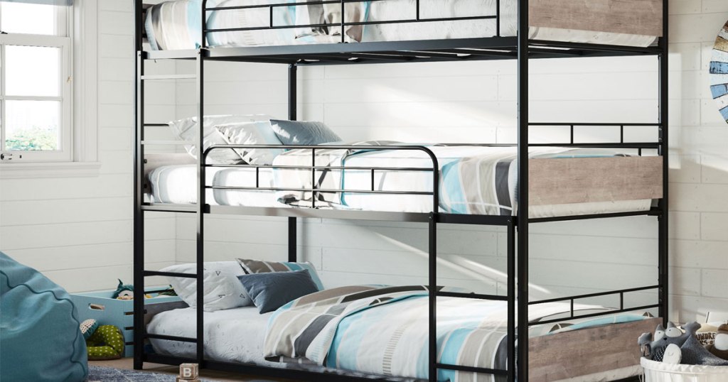 black metal bunk bed with wood panels at foot of bed assembled in a kids room