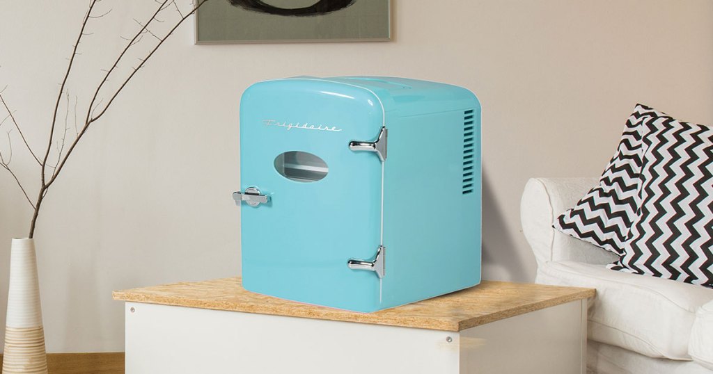 light blue mini fridge sitting on a table in a living room