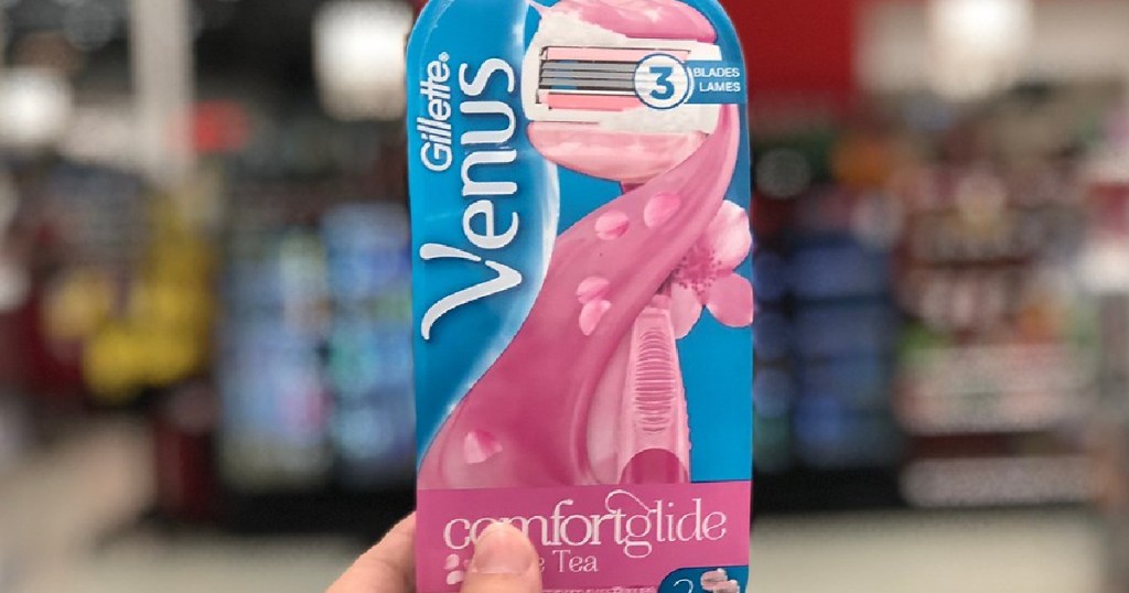 hand holding women's razor and refills in store