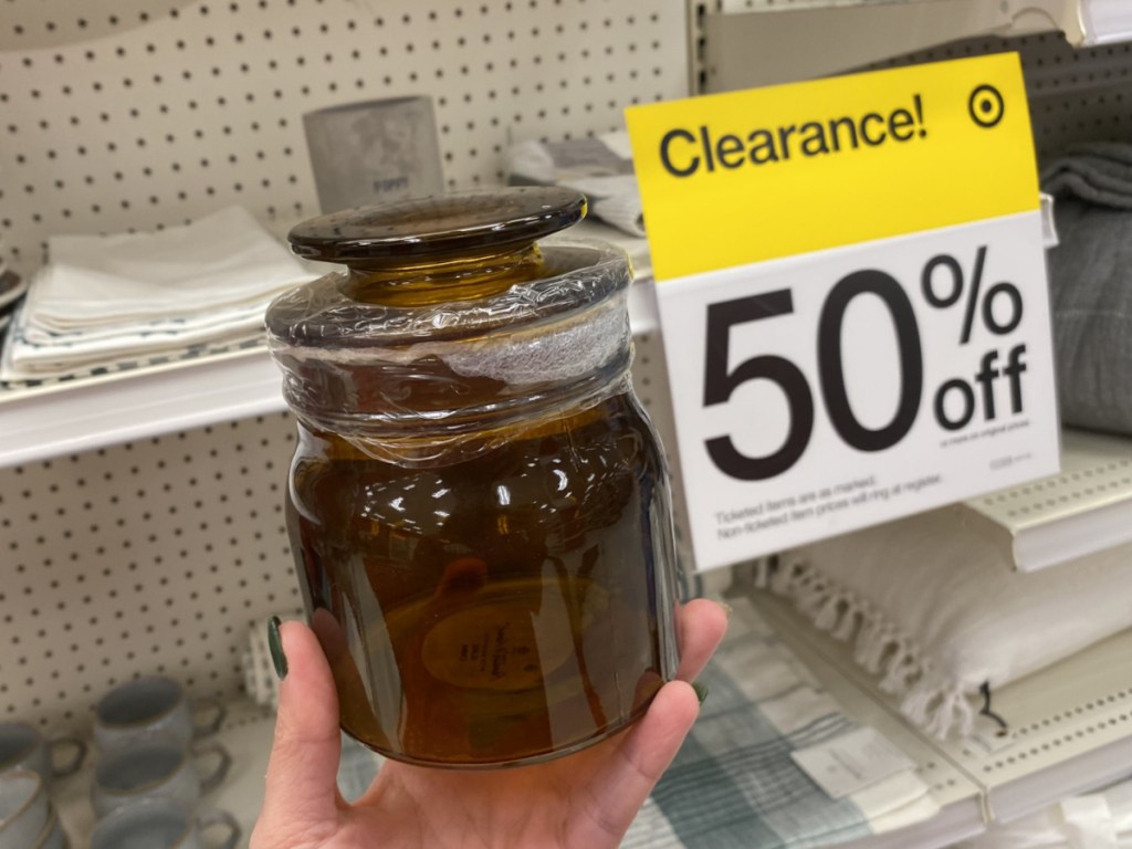 hand holding a hearth and hand with magnolia amber jar at target