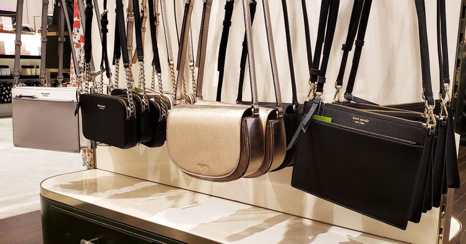 various colors and styles of kate spade crossbody bags on display at store