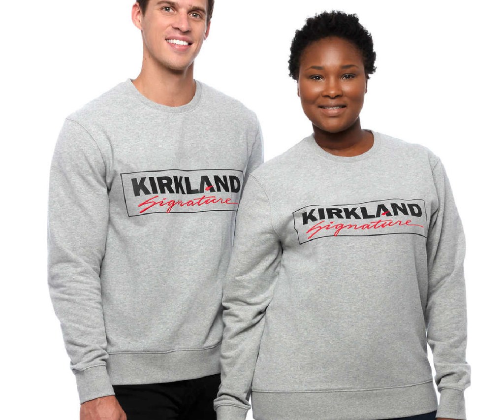 man and woman in gray logo sweatshirts