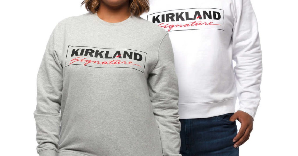 woman in gray logo sweatshirt and man in white logo sweatshirt