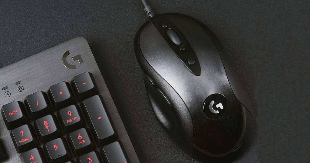 black logitech mouse on a black mousepad next to a black logitech keyboard