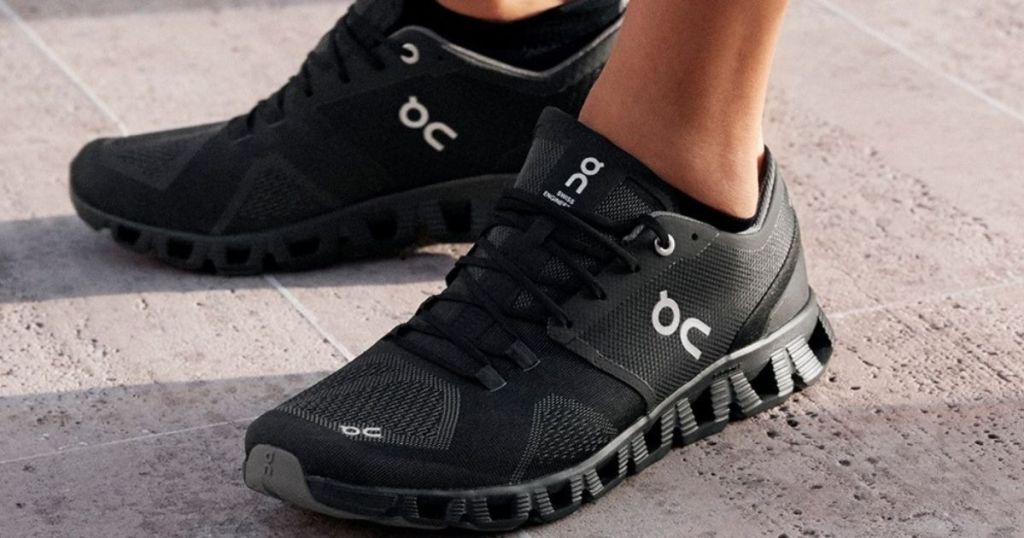 person wearing a pair of black running shoes