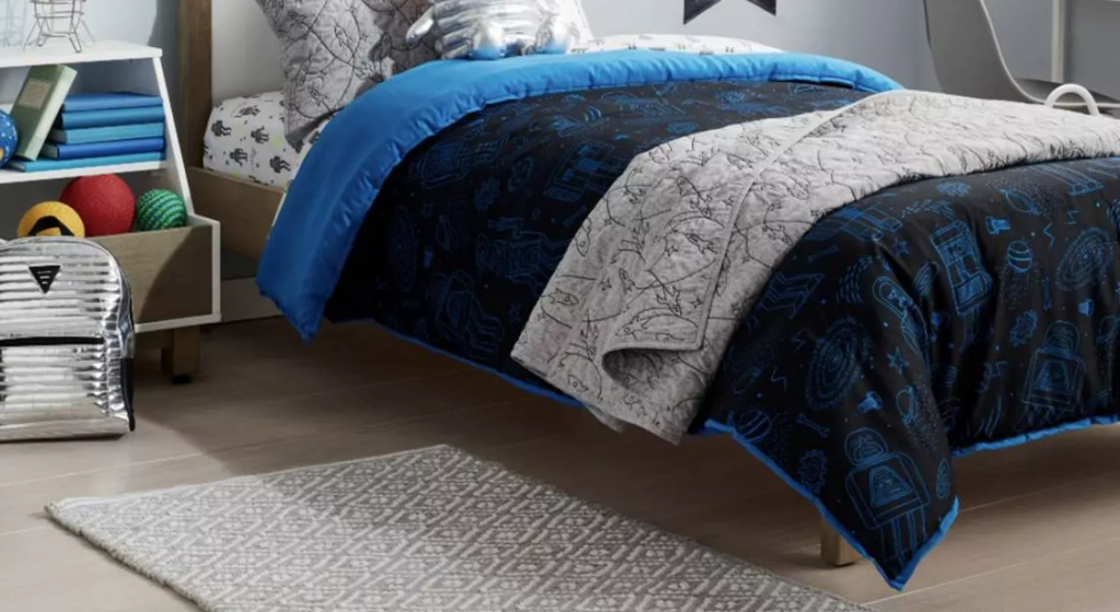 kids room with bed, rug and stand