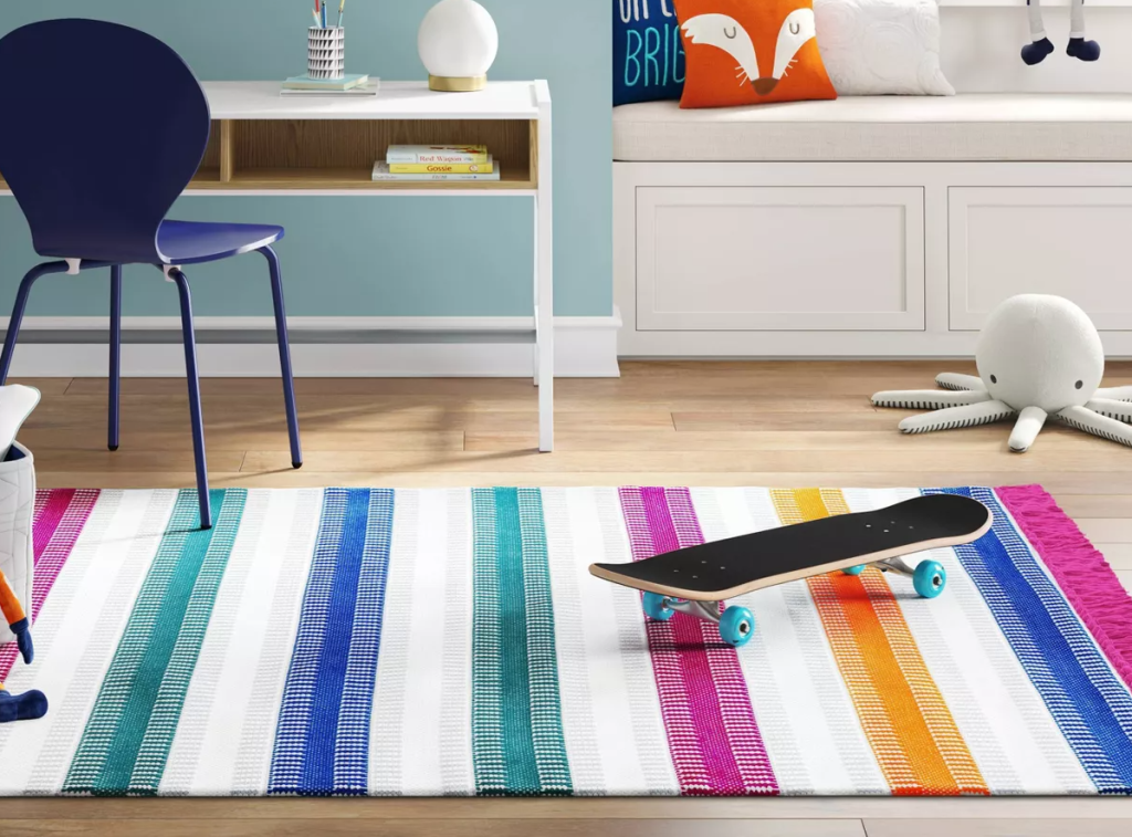 kids room with a desk, skateboard and large area rug