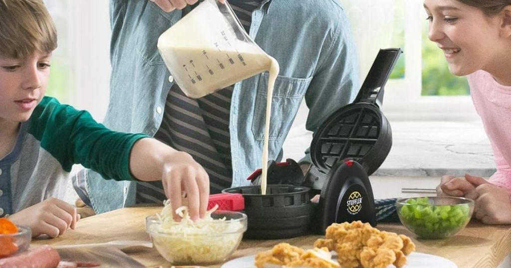 family making waffles with a waffle maker