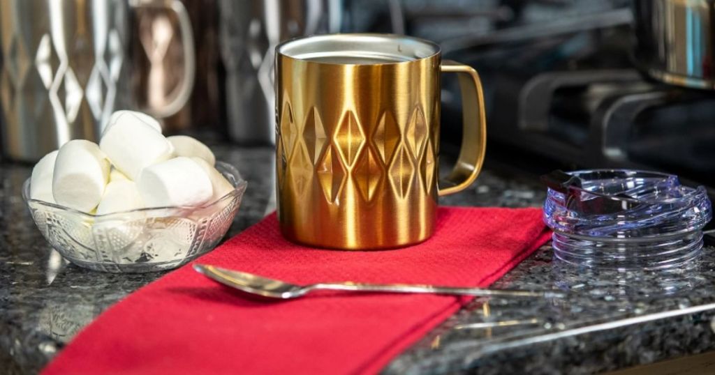 mug with a spoon and marshmallows near it