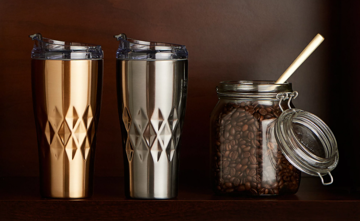 two tumblers by a container of coffee