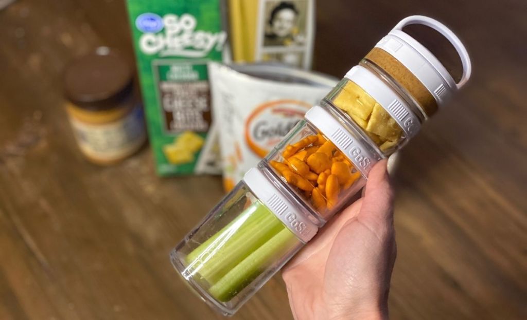 A hand holding snacks in jars