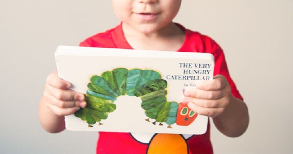 Child holding The Very Hungry Caterpillar Board Book
