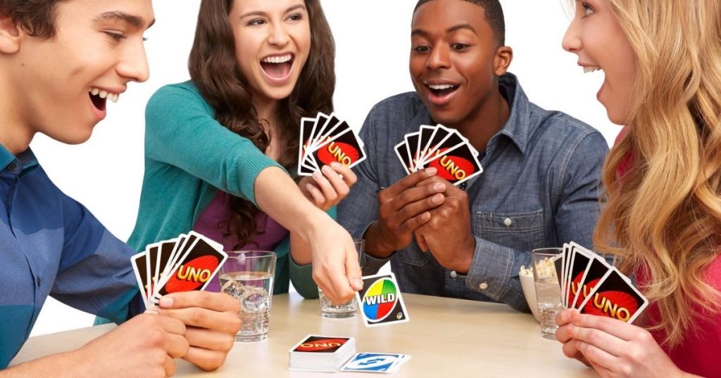 four people playing UNO card game