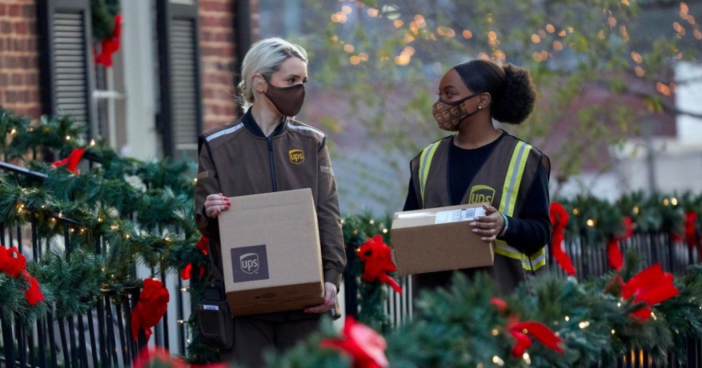 2 woman working for ups standing outside holding packages