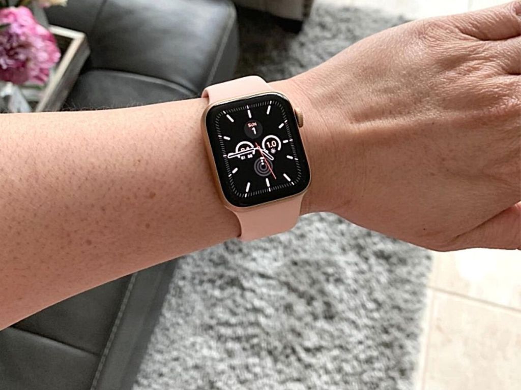 pink apple watch on hand
