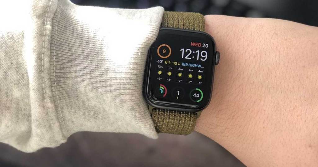 man holding up wrist with apple watch band