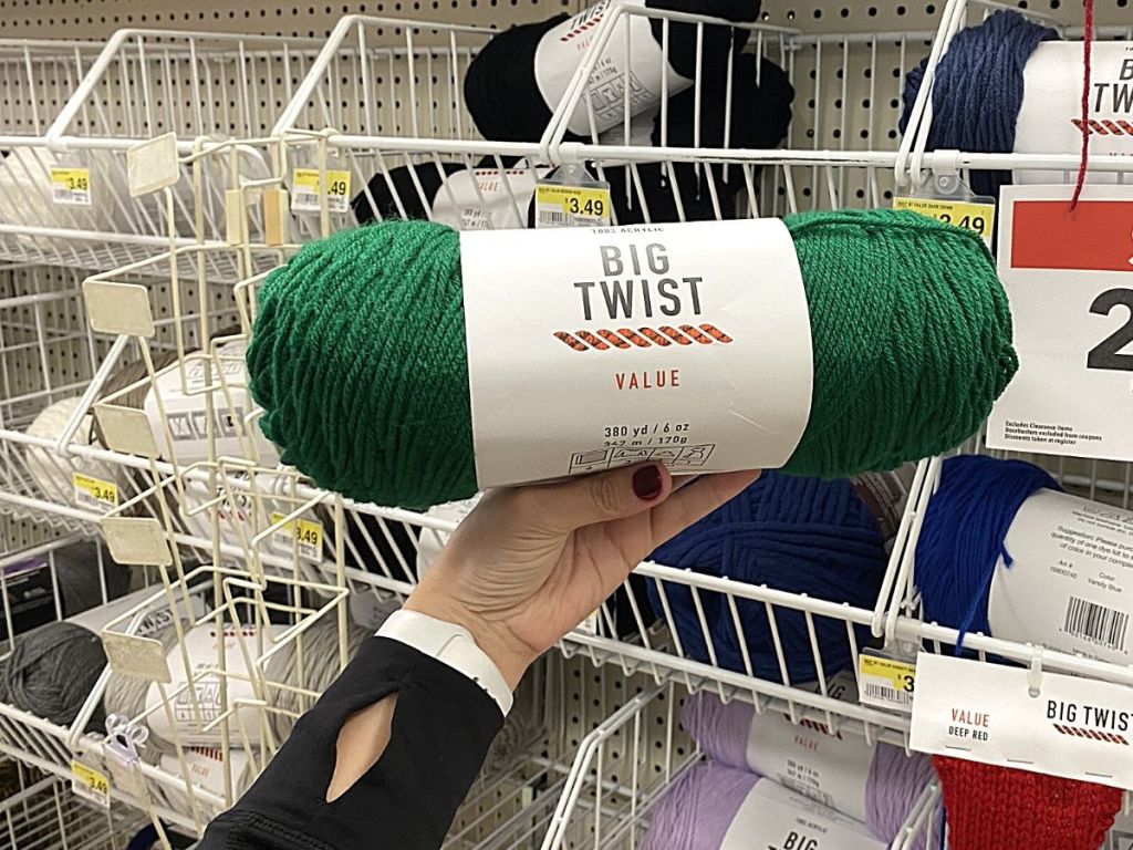 hand holding spool of yarn