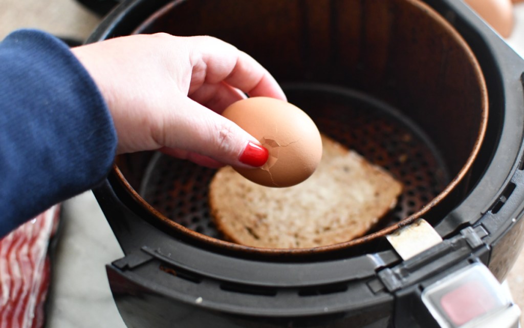 cracking egg on toast