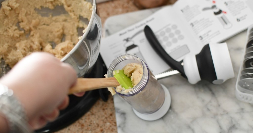 filling cookie press with cookie dough