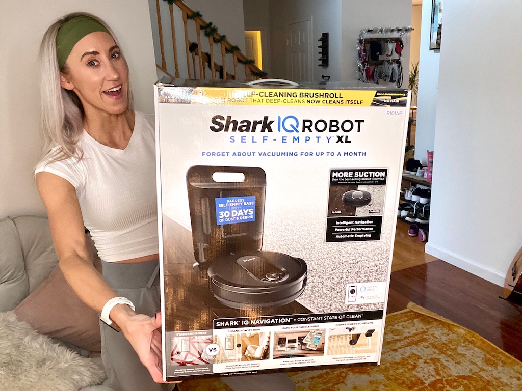 holding large Shark IQ Robot vacuum large box 