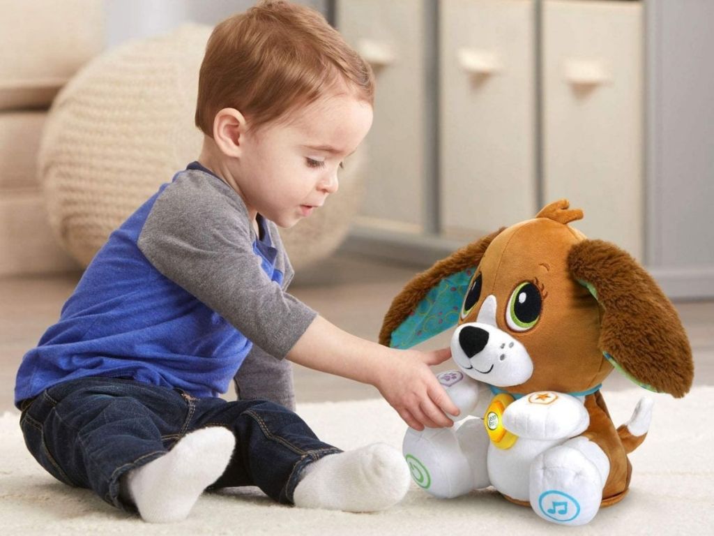 boy playing with dog stuffed animal