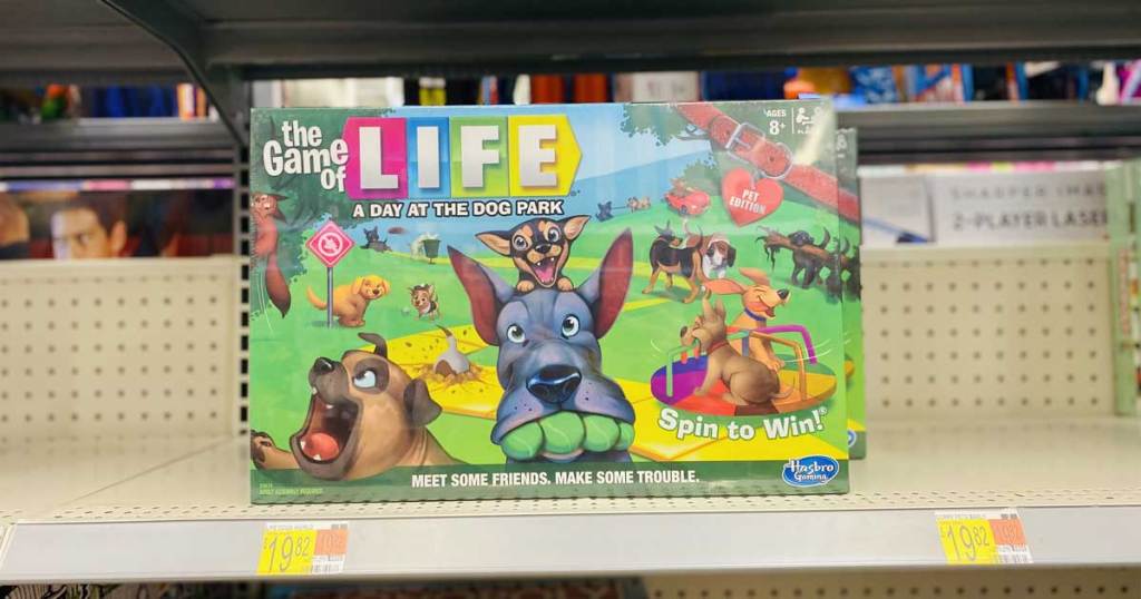 hand holding a board game with dogs on it