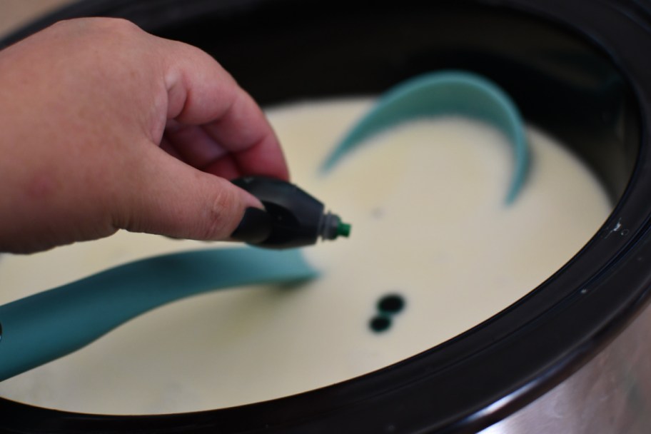pouring food coloring into melted chocolate