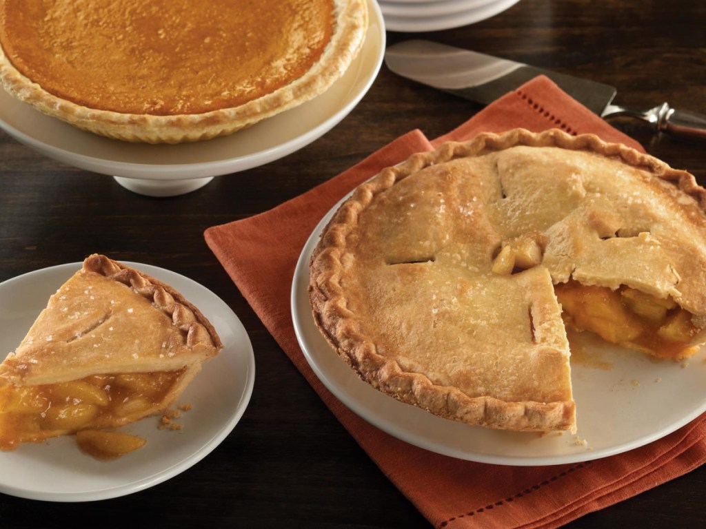 pumpkin and apple pie on table