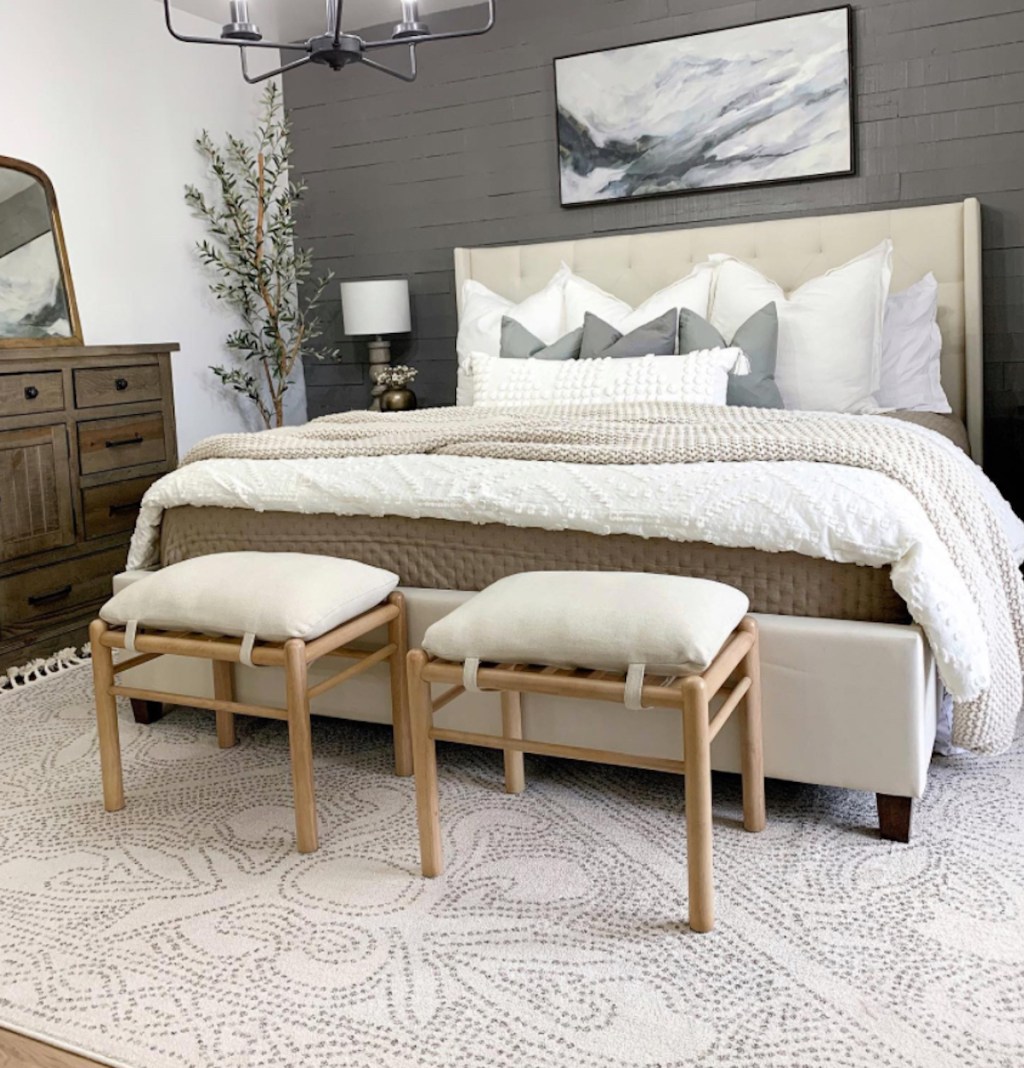 styled serena and lily master bedroom with stools and neutral rug