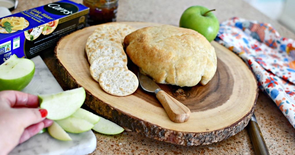 serving baked brie with crackers and apples