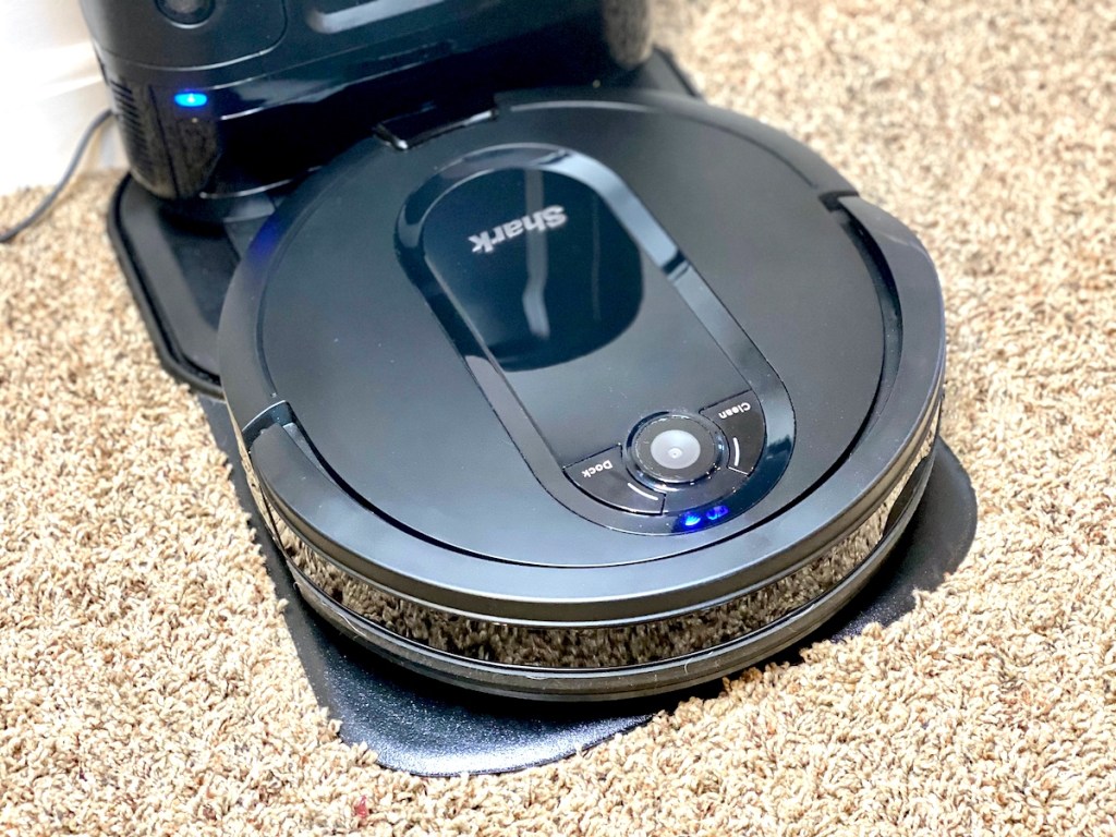 shark robot vacuum sitting on carpet floor