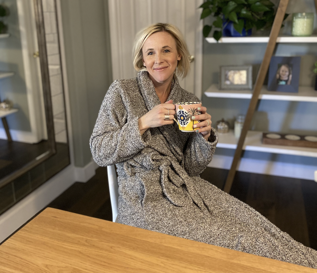woman drinking coffee while wearing Barefoot Dreams robe dupe