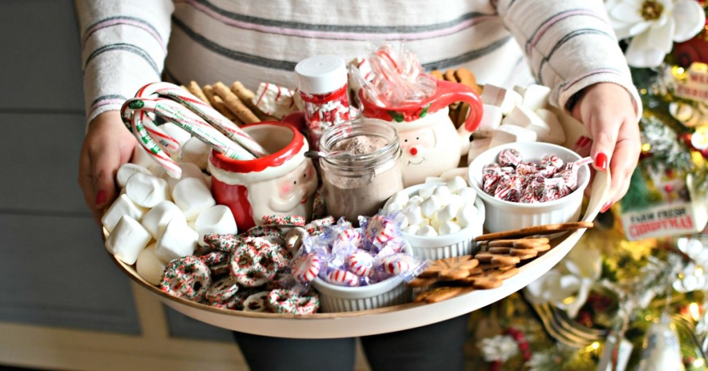 woman holding a hot cocoa charcuterie board