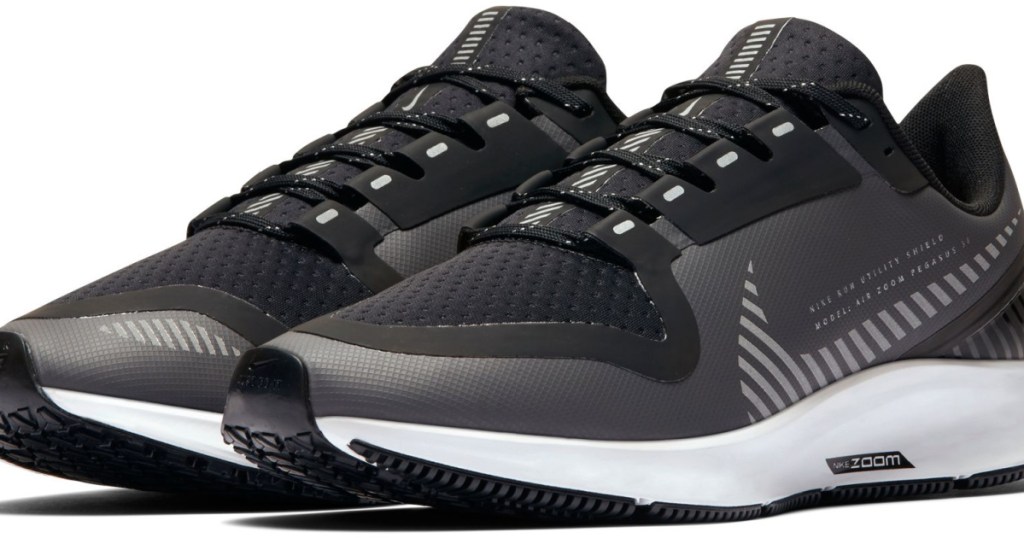 dark grey pair of nike shoes on white background
