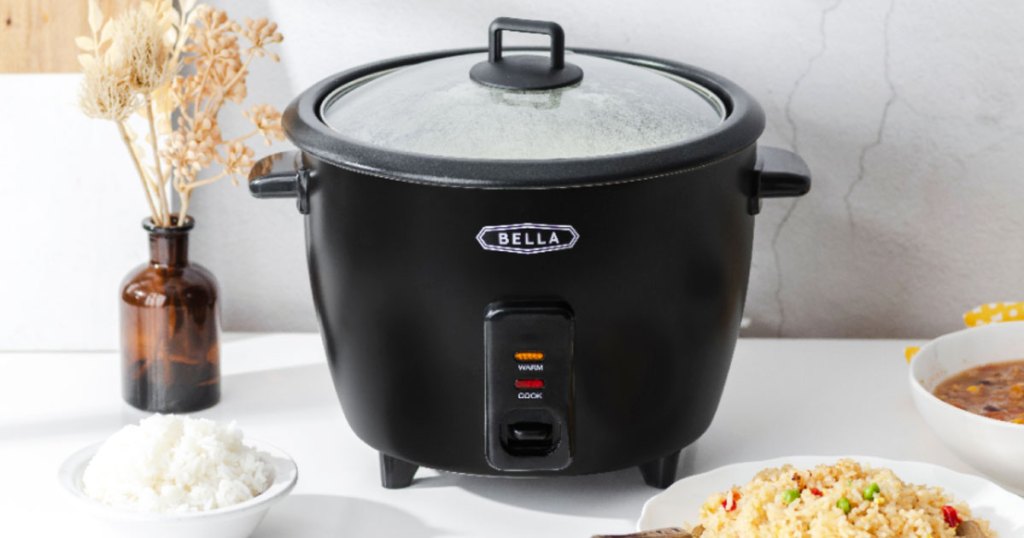 black rice cooker with glass lid sitting on kitchen counter