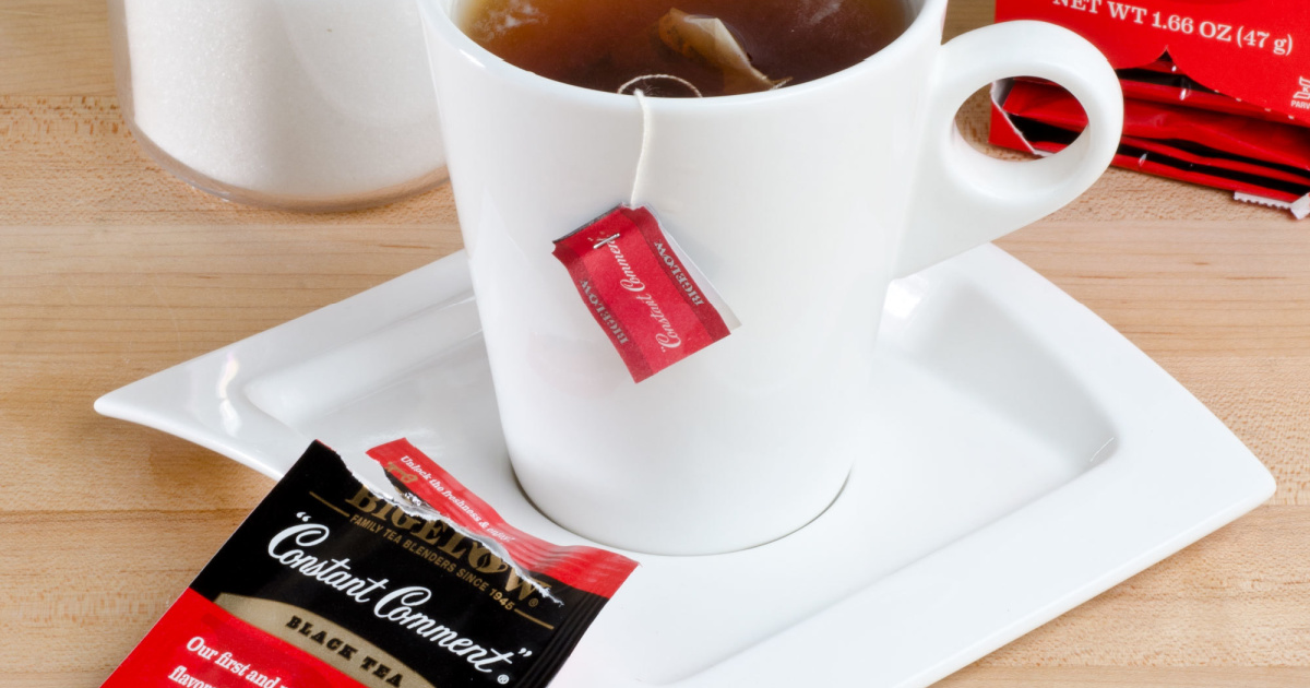 black tea bag in white mug and open bag