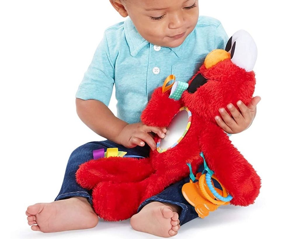 boy with Bright Starts Sesame Street Elmo Travel Buddy Take-Along Toy