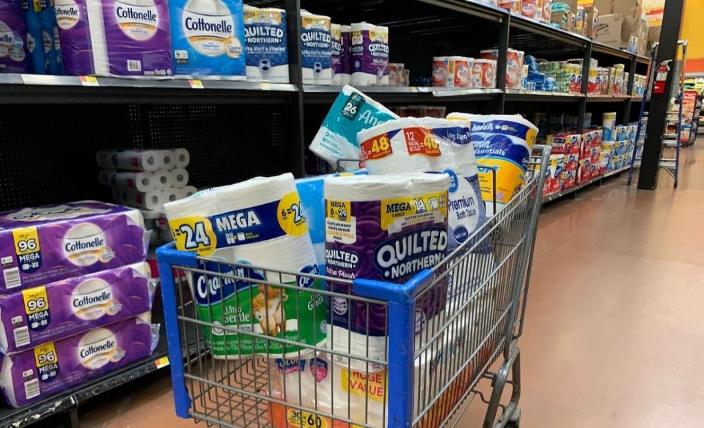 A grocery cart full of bath tissue at a store