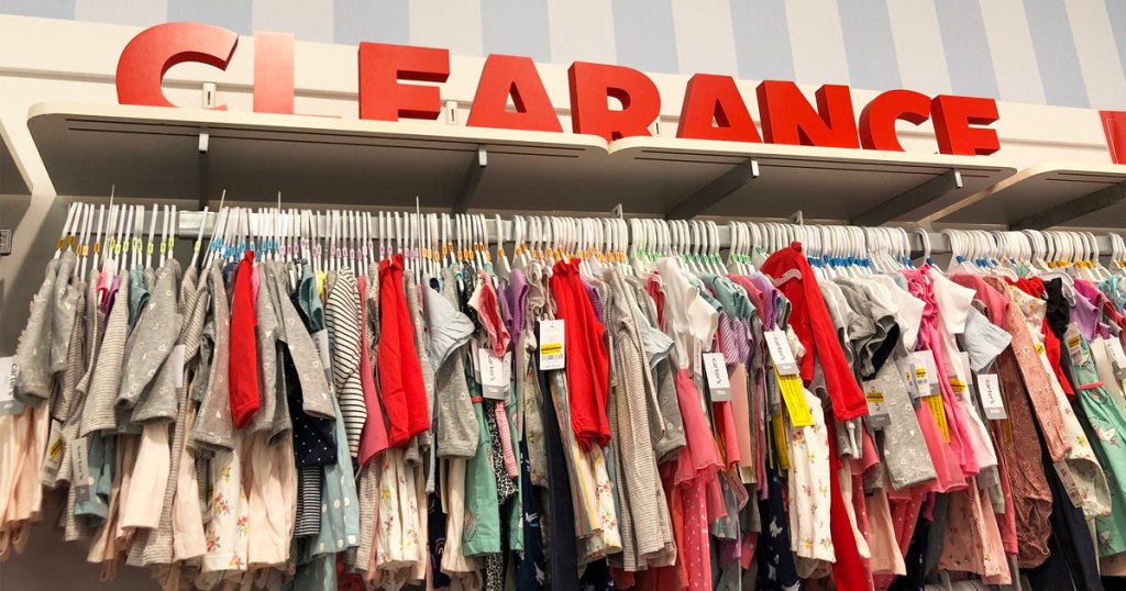 display rack of carter's clothes with large red letters above it that says clearance