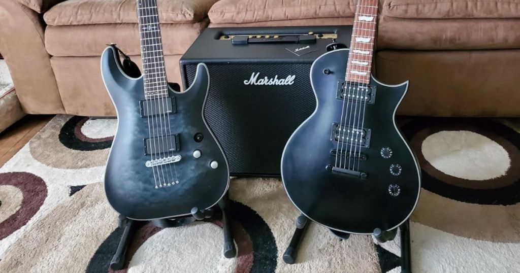 two guitars on stands