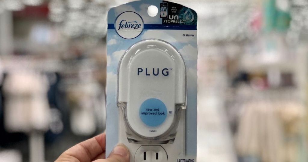 hand holding a Febreze Plug Warmer