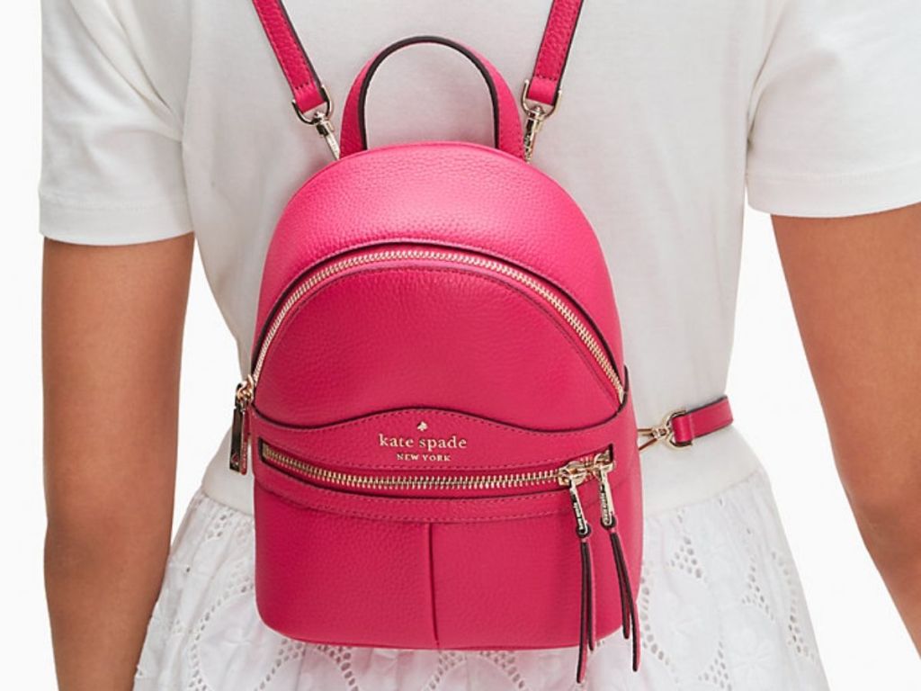 lady in white wearing Kate Spade Mini Backpack