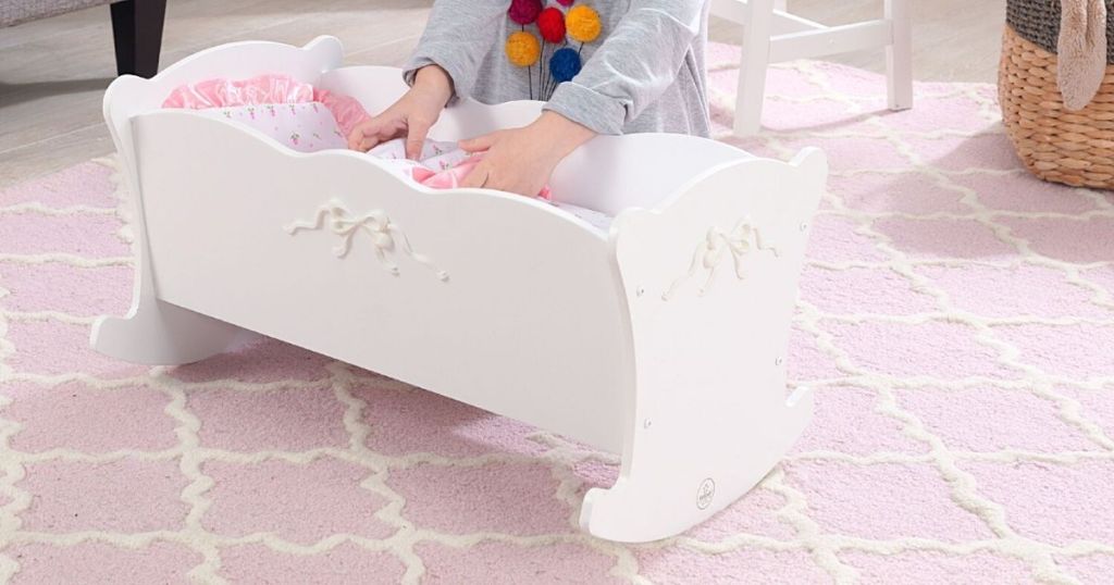 white wood doll crib in kids room