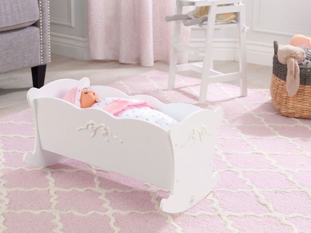 baby doll in white doll crib