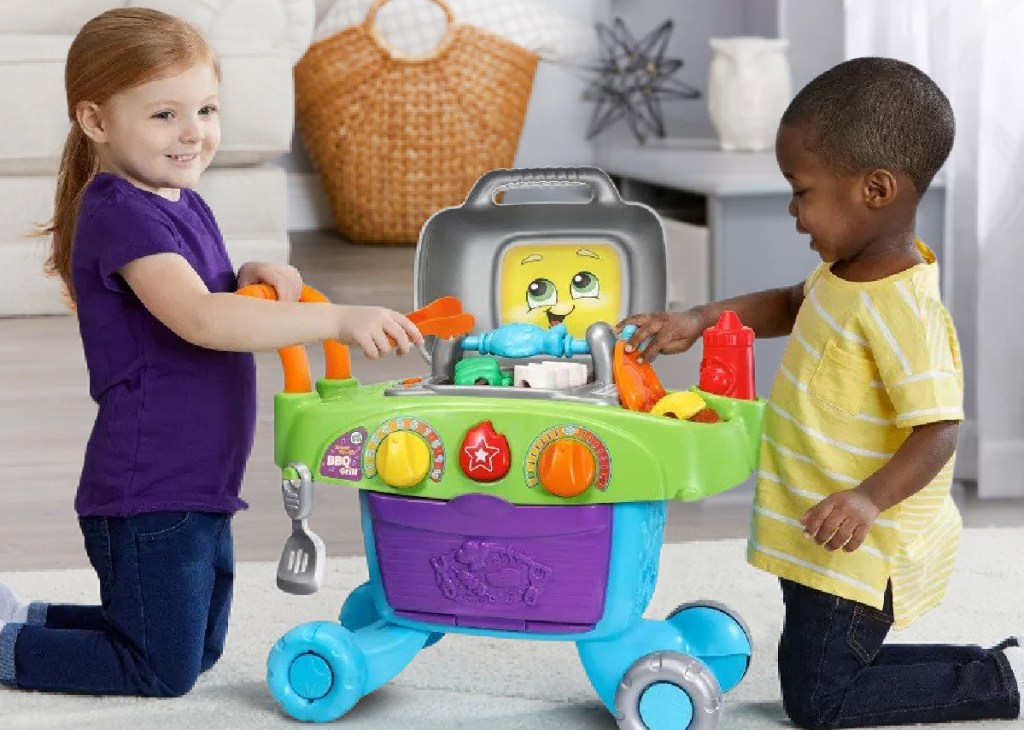 two kids playing with LeapFrog Smart Sizzlin' BBQ Grill