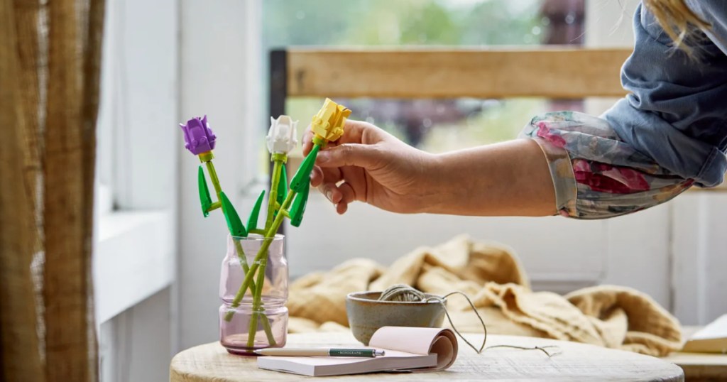 woman touching a LEGO tulip building set 